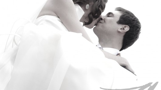 Fotografía de bodas. Fotografía en blanco y negro del novio cogiendo a la novia en brazos